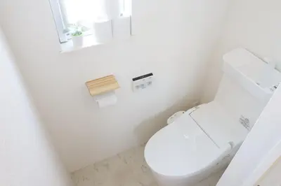 a white bathroom with a toilet and a window at Dori Dori House Shinjuku1 in Tokyo