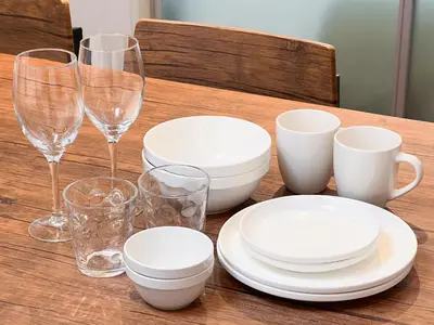 a wooden table with plates and glasses on it at \u30f4\u30a3\u30e9\u4ee3\u3005\u6728101 in Tokyo