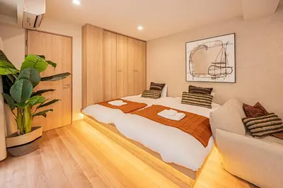a bedroom with a large bed and a couch at Mi-HOTEL SUGAMO in Tokyo