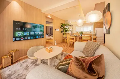 a living room with a couch and a table at Mi-HOTEL SUGAMO in Tokyo