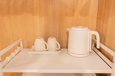 two white appliances sitting on top of a shelf at Mi-HOTEL SUGAMO in Tokyo