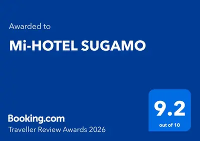 a blue sign with the words mh hotel sugas at Mi-HOTEL SUGAMO in Tokyo
