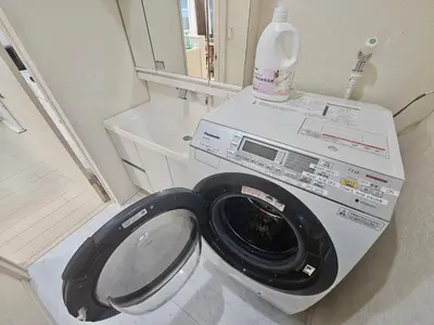 a washing machine in a bathroom with a mirror at Near Ikebukuro! 2min to Kita Ikebukuro Large House in Tokyo