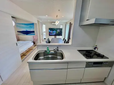 a kitchen with a sink and a living room at Near Ikebukuro! 2min to Kita Ikebukuro Large House in Tokyo