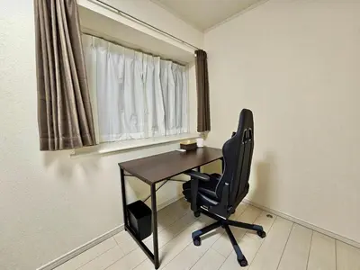 a desk and a chair in a room with a window at Near Ikebukuro! 2min to Kita Ikebukuro Large House in Tokyo