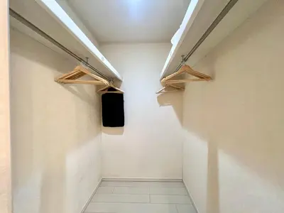a walk in closet with wooden shelves in a room at Near Ikebukuro! 2min to Kita Ikebukuro Large House in Tokyo