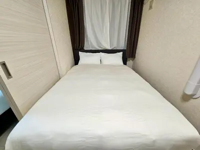 a large white bed in a small room at Near Ikebukuro! 2min to Kita Ikebukuro Large House in Tokyo