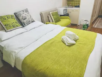 a bedroom with a large bed with two towels on it at Shinjuku\u65b0\u5bbf1min in Tokyo