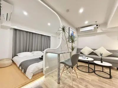 a bedroom with a bed and a table and a couch at NEW & Spacious home in Tokyo