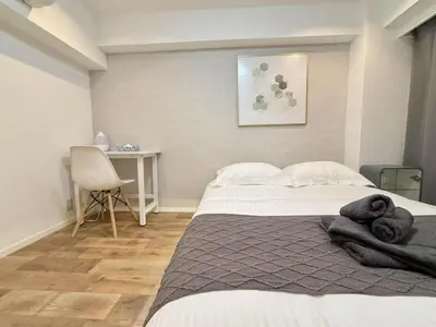 a bedroom with a bed with towels on it at NEW & Spacious home in Tokyo