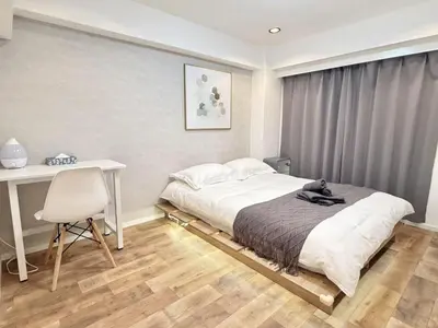 a bedroom with a bed and a desk and a chair at NEW & Spacious home in Tokyo