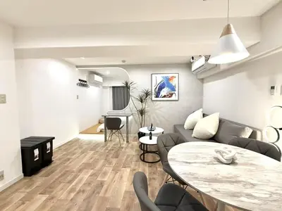 a living room with a couch and a table at NEW & Spacious home in Tokyo