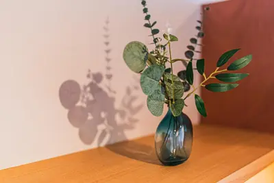a vase with a plant in it on a table at AT Shinjuku in Tokyo