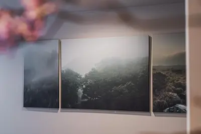 four paintings on a wall with a forest at AT Shinjuku in Tokyo