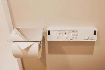 a toilet paper dispenser with a roll of toilet paper at AT Shinjuku in Tokyo