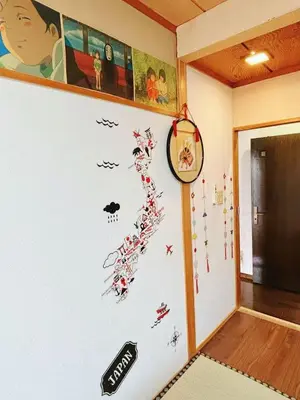a room with a wall with a clock on it at Direct to Shinjuku 15 mins 3rooms Up to 9 Guests in Tokyo