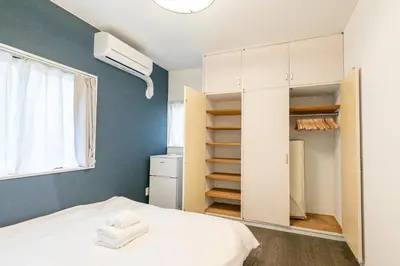 a bedroom with a bed and a closet at Marble TOKYO Base Tabata 101 in Tokyo