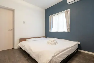 a bedroom with a large bed with a window at Marble TOKYO Base Tabata 101 in Tokyo