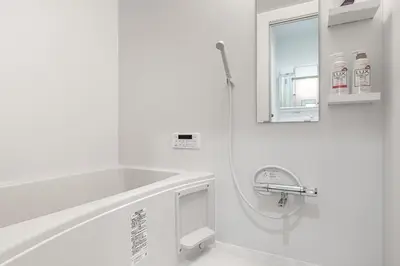a white bathroom with a sink and a mirror at Marble TOKYO Base Tabata 101 in Tokyo