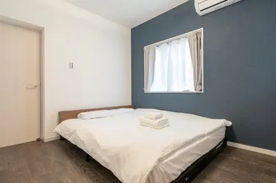 a bedroom with a large bed with a window at Marble TOKYO Base Tabata 101 in Tokyo