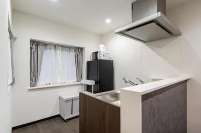 a small kitchen with a sink and a refrigerator at Marble TOKYO Base Tabata 101 in Tokyo