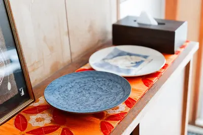 a table with two plates and a box on it at Luna Nest Ikebukuro in Tokyo