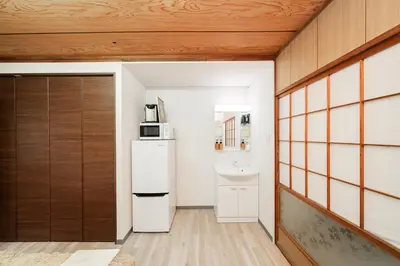 a kitchen with a refrigerator and a sink at Luna Nest Ikebukuro in Tokyo