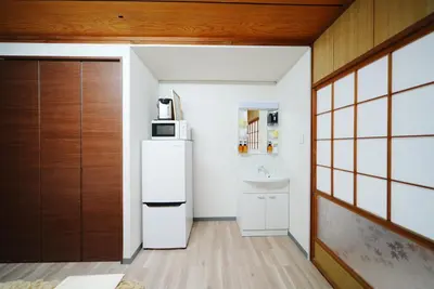a kitchen with a refrigerator and a sink at Luna Nest Ikebukuro in Tokyo