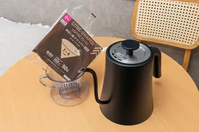 a coffee maker on a table next to a bag of chocolate at 5 min to Shibuya, Easy Access to Hot Spots in Tokyo