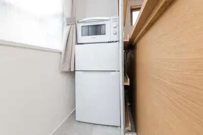 a microwave on top of a refrigerator in a room at 5 min to Shibuya, Easy Access to Hot Spots in Tokyo