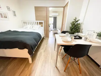 a bedroom with a bed and a desk and a table at M107 8mins from Ikebukuro sta 9min to Shinjuku byTrain in Tokyo