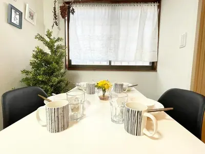 a white table with chairs and a christmas tree at M101 8mins from Ikebukuro sta 9min to Shinjuku byTrain in Tokyo