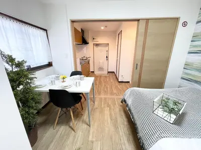 a living room with a white table and a couch at M101 8mins from Ikebukuro sta 9min to Shinjuku byTrain in Tokyo