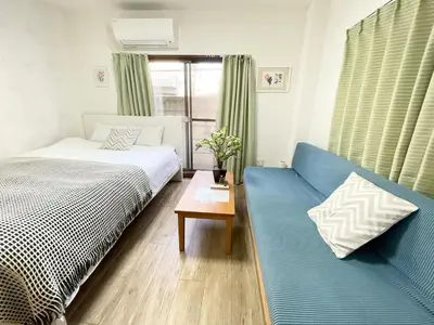 a bedroom with a bed and a blue couch at M101 8mins from Ikebukuro sta 9min to Shinjuku byTrain in Tokyo