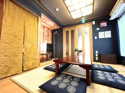 a room with a table and some pillows on the floor at HOTEL Kita-Shinagawa in Tokyo
