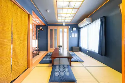 a room with a table and blue walls at HOTEL Kita-Shinagawa in Tokyo