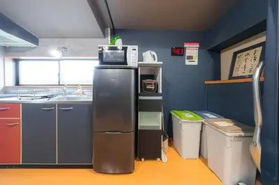 a small kitchen with a sink and a refrigerator at HOTEL Kita-Shinagawa in Tokyo