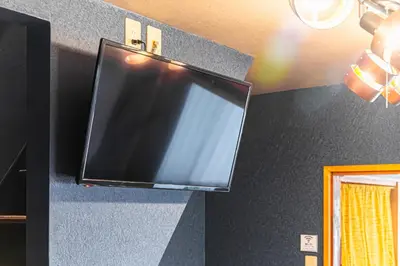 a flat screen tv hanging on a wall at HOTEL Kita-Shinagawa in Tokyo