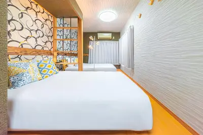 a room with two white beds and a window at HOTEL Kita-Shinagawa in Tokyo