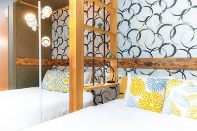 a bedroom with a wooden bunk bed with pillows at HOTEL Kita-Shinagawa in Tokyo