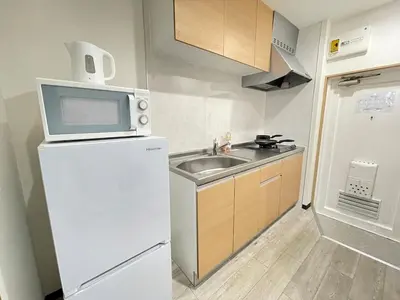 a kitchen with a sink and a microwave on top of a refrigerator at M102 8 mins from Ikebukuro sta9 min to Shinjuku by Train in Tokyo