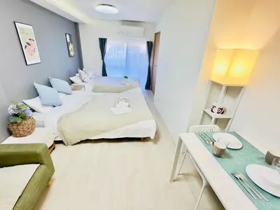 a small room with two beds and a table at M103 8 mins to Ikebukuro sta in Tokyo