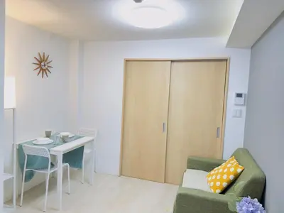 a living room with a couch and a table and a door at M103 8 mins to Ikebukuro sta in Tokyo