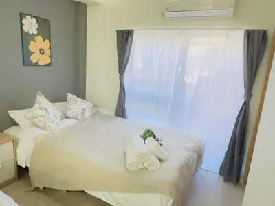 a bedroom with a white bed with towels on it at M103 8 mins to Ikebukuro sta in Tokyo