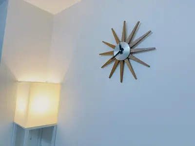 a clock hanging on a wall in a room at M103 8 mins to Ikebukuro sta in Tokyo