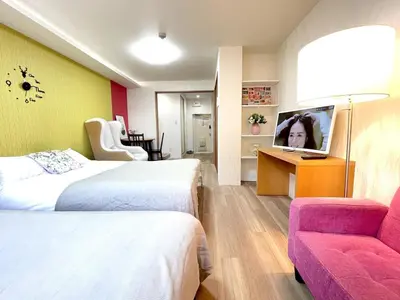 a hotel room with two beds and a flat screen tv at M108 8 mins to Ikebukuro sta in Tokyo