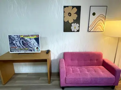 a living room with a pink couch and a table at M108 8 mins to Ikebukuro sta in Tokyo