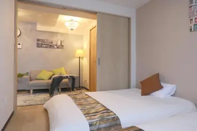 a hotel room with two beds and a couch at Ikebukuro area 6mins from sta Max6 2 bedrooms N202 in Tokyo