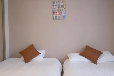 two beds sitting next to each other in a room at Ikebukuro area 6mins from sta Max6 2 bedrooms N202 in Tokyo