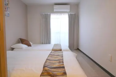 a hotel room with two beds and a window at Ikebukuro area 6mins from sta Max6 2 bedrooms N202 in Tokyo